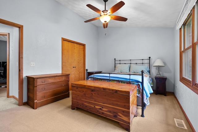 bedroom featuring light carpet, baseboards, and ceiling fan