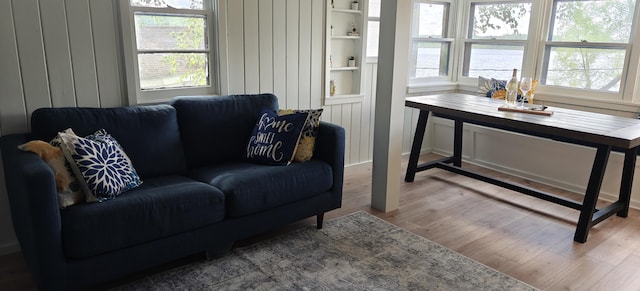 living area featuring healthy amount of natural light and wood finished floors