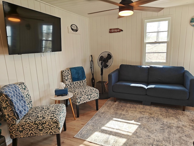 living room with wood finished floors and ceiling fan