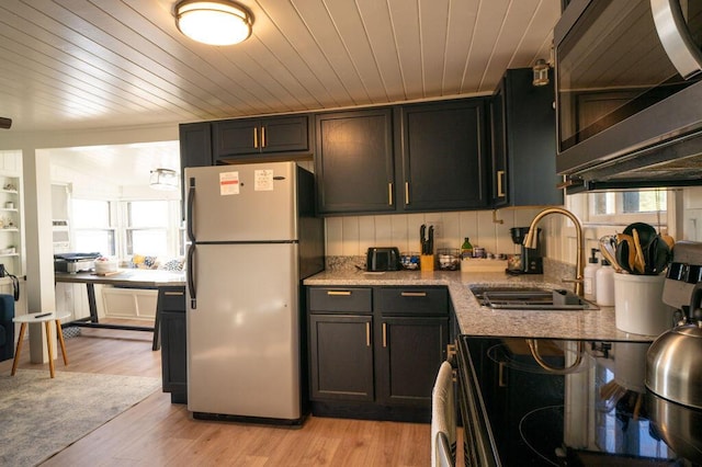 6294 Rock Rd, Lake, MI 48632 - kitchen featuring freestanding refrigerator, a sink, stainless steel microwave, plenty of natural light, and wood ceiling