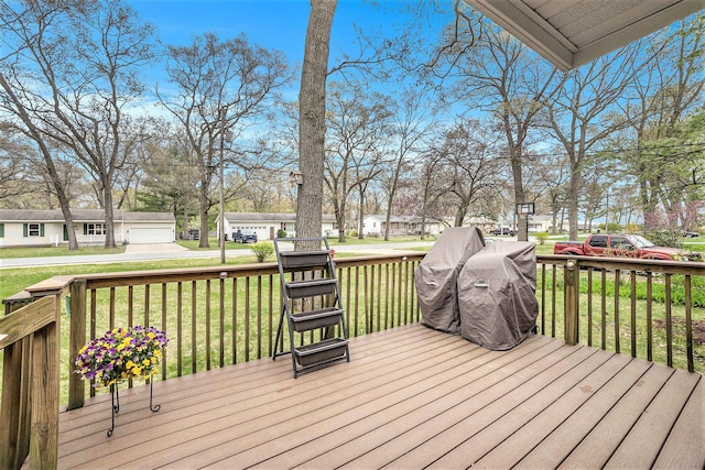 wooden deck featuring a lawn and a residential view