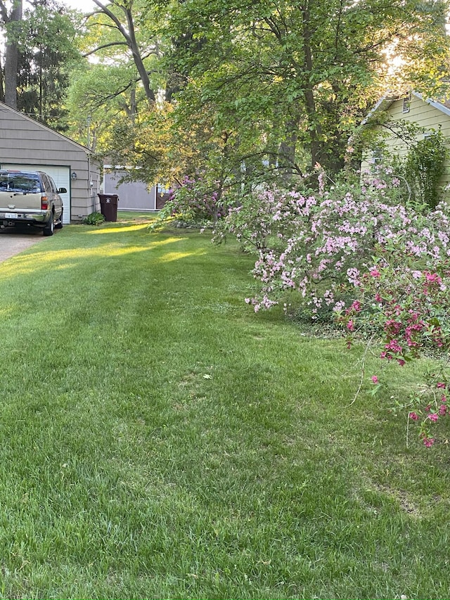 view of grassy yard with a garage