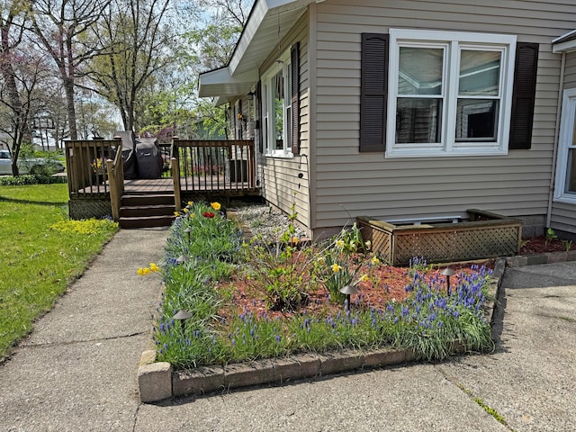 view of side of property featuring a wooden deck
