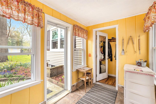 interior space with ornamental molding and baseboards