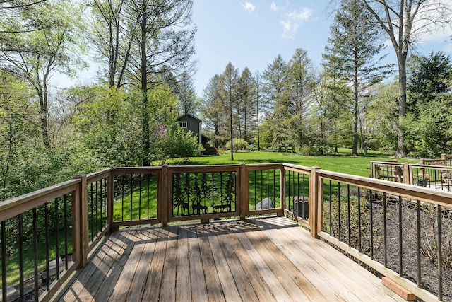 wooden deck featuring a yard