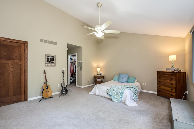bedroom featuring carpet, a walk in closet, high vaulted ceiling, baseboards, and a closet