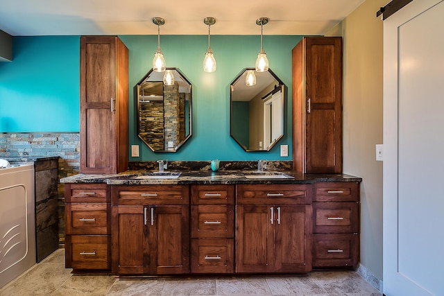 full bath with double vanity and washer / clothes dryer