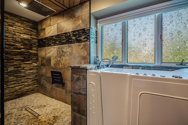 full bathroom featuring tiled shower and a bath