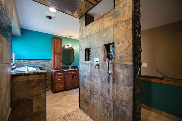 bathroom featuring vanity, a garden tub, tile patterned flooring, tile walls, and a tile shower