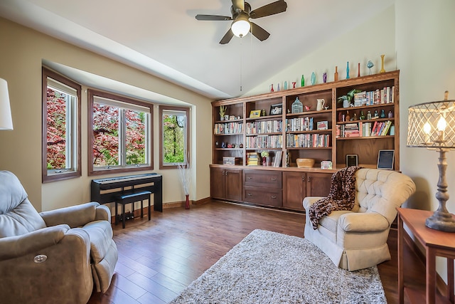 sitting room with ceiling fan, lofted ceiling, and dark wood-type flooring