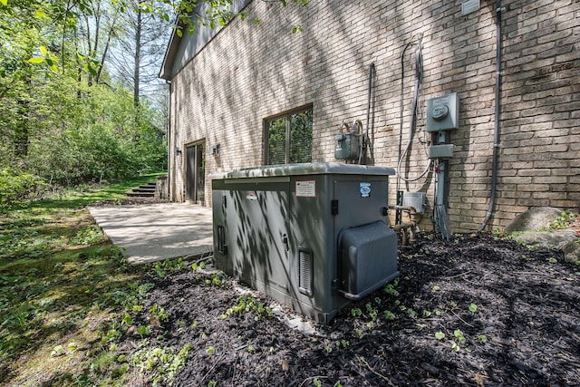 exterior view of gas meter, electric meter, and brick siding