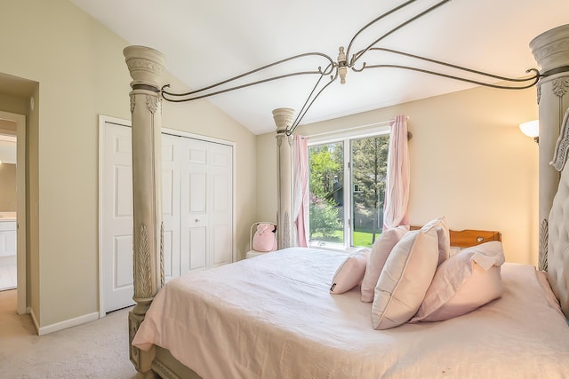bedroom with light colored carpet, vaulted ceiling, a closet, and baseboards