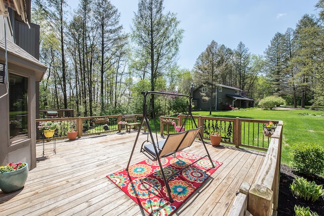 wooden terrace featuring a yard and view of wooded area