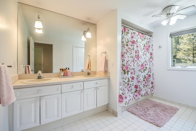 bathroom with a shower with curtain, double vanity, and tile patterned flooring