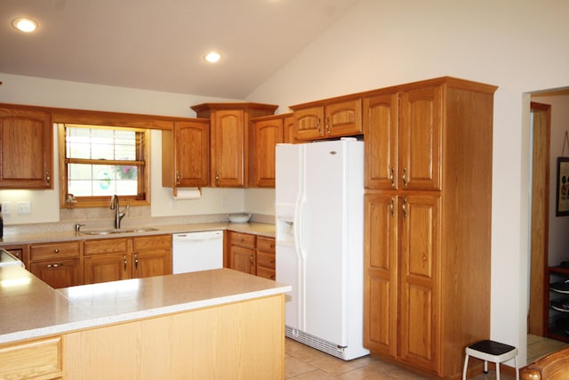 kitchen with white appliances, a sink, lofted ceiling, light countertops, and recessed lighting