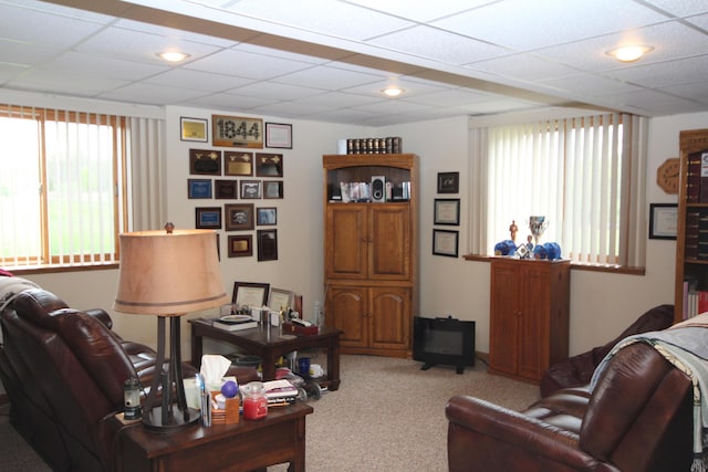 living area with carpet and a drop ceiling