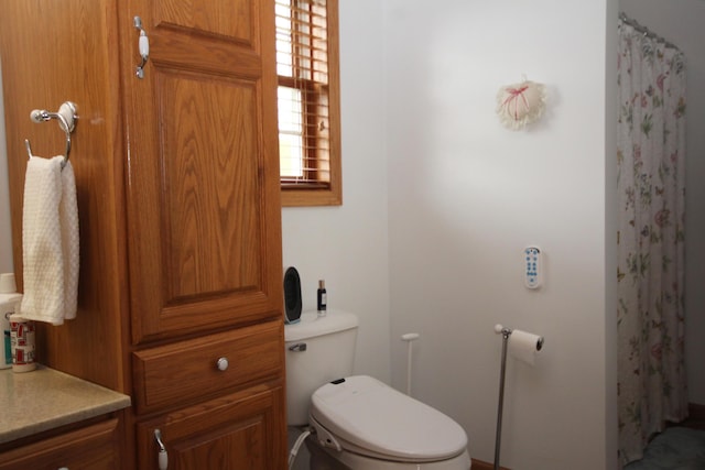 bathroom with toilet and a shower with shower curtain