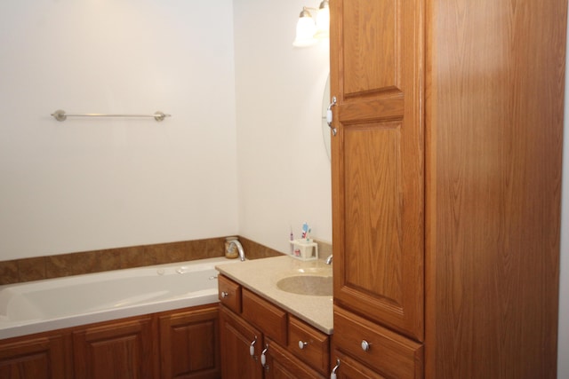 bathroom with vanity and a bath