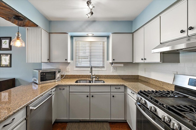 1160 S Baldwin Rd, Lake Orion, MI 48360 - kitchen with stainless steel appliances, a sink, under cabinet range hood, and decorative backsplash