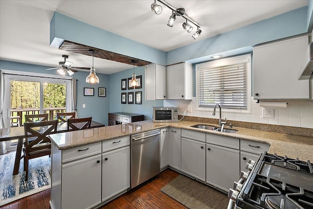 1160 S Baldwin Rd, Lake Orion, MI 48360 - kitchen with appliances with stainless steel finishes, a sink, a peninsula, dark wood-style flooring, and ceiling fan