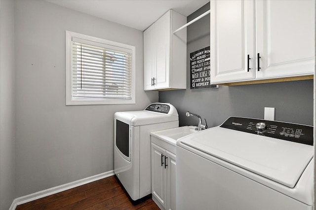 1160 S Baldwin Rd, Lake Orion, MI 48360 - washroom featuring separate washer and dryer, baseboards, dark wood-style flooring, and cabinet space