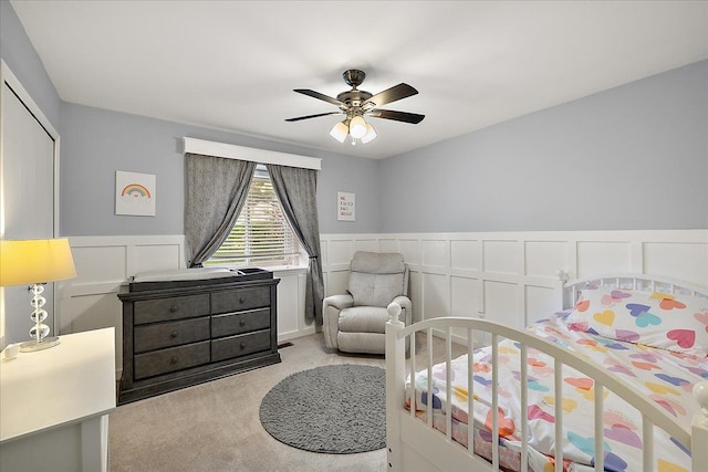 1160 S Baldwin Rd, Lake Orion, MI 48360 - bedroom with light colored carpet, a wainscoted wall, a decorative wall, ceiling fan, and a closet