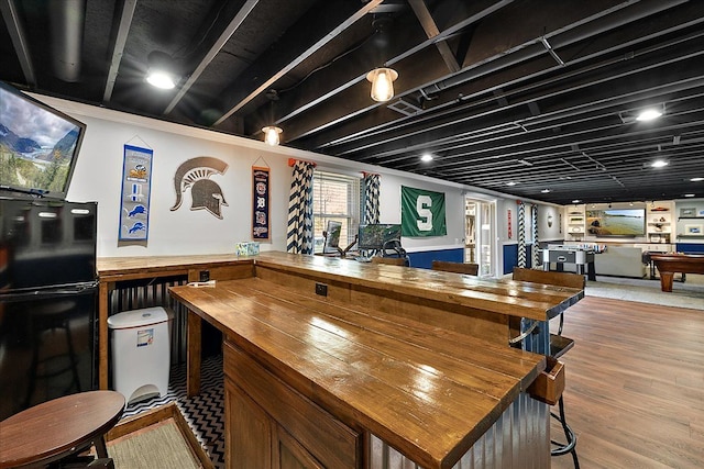1160 S Baldwin Rd, Lake Orion, MI 48360 - indoor dry bar featuring freestanding refrigerator and wood finished floors