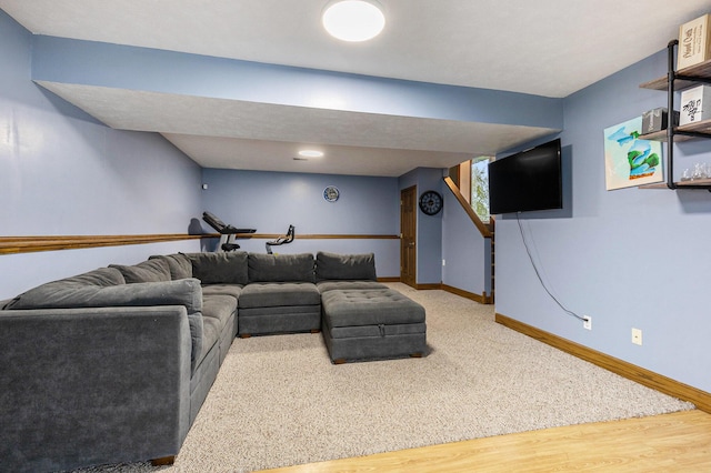living area featuring baseboards and wood finished floors