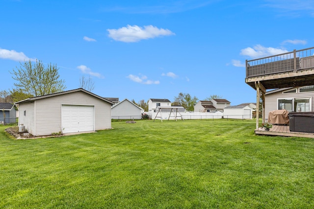 view of yard with a deck, an outbuilding, and a garage