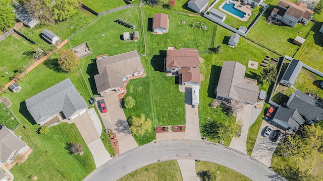 view of property location with a pool and nearby suburban area
