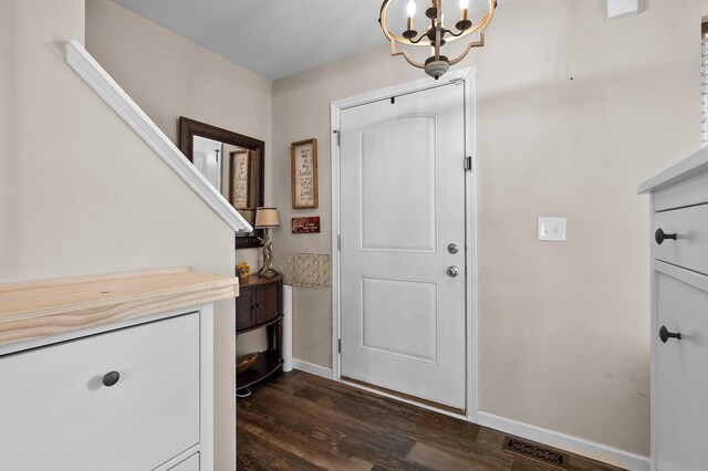 72597 Faye Ct, South Haven, MI 49090 - foyer with dark wood-style floors, a chandelier, and baseboards