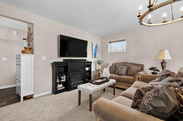 72597 Faye Ct, South Haven, MI 49090 - living room featuring carpet floors, baseboards, and a chandelier