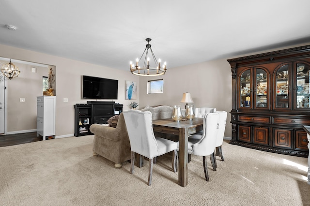72597 Faye Ct, South Haven, MI 49090 - dining room featuring a chandelier, carpet floors, and baseboards