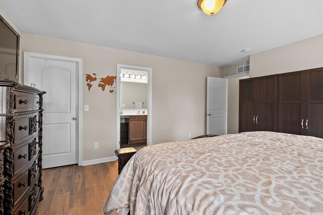 72597 Faye Ct, South Haven, MI 49090 - bedroom with wood finished floors, baseboards, and connected bathroom