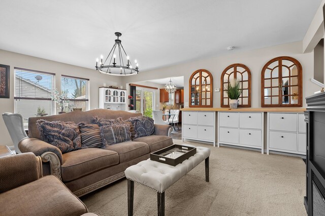 72597 Faye Ct, South Haven, MI 49090 - living room featuring a chandelier, healthy amount of natural light, and light colored carpet