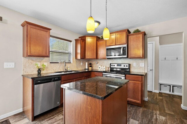 72597 Faye Ct, South Haven, MI 49090 - kitchen with stainless steel appliances, a sink, dark wood-type flooring, brown cabinetry, and decorative backsplash