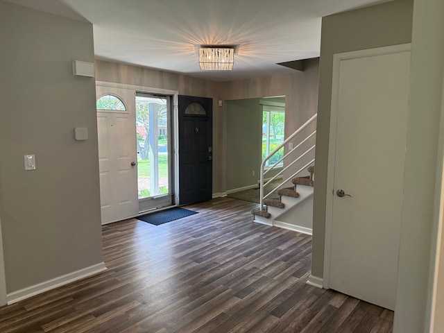 entrance foyer featuring baseboards, dark wood-style flooring, stairway, and healthy amount of natural light