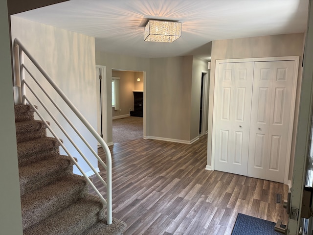 stairs featuring wood finished floors and baseboards
