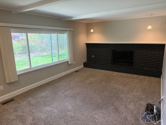 unfurnished living room with beamed ceiling, carpet floors, baseboards, and a brick fireplace