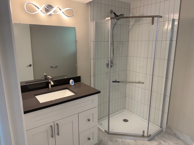 bathroom featuring a shower stall, vanity, and marble finish floors