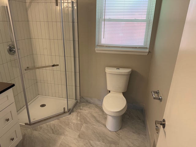 full bathroom featuring a shower stall, toilet, and vanity