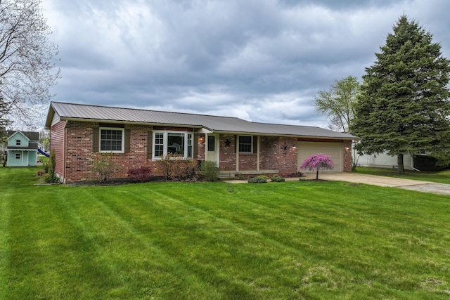 single story home with brick siding, an attached garage, driveway, a front yard, and metal roof