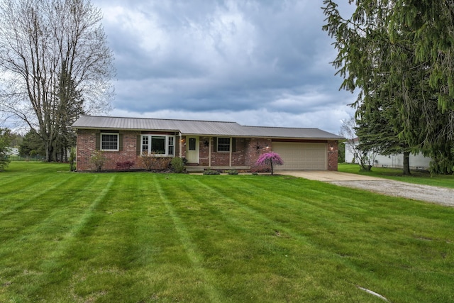 ranch-style house with concrete driveway, brick siding, a garage, a front yard, and metal roof