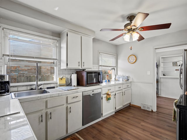 24730 Ridgedale St, Oak Park, MI 48237 - kitchen featuring appliances with stainless steel finishes, ceiling fan, a wainscoted wall, white cabinetry, and dark wood-type flooring