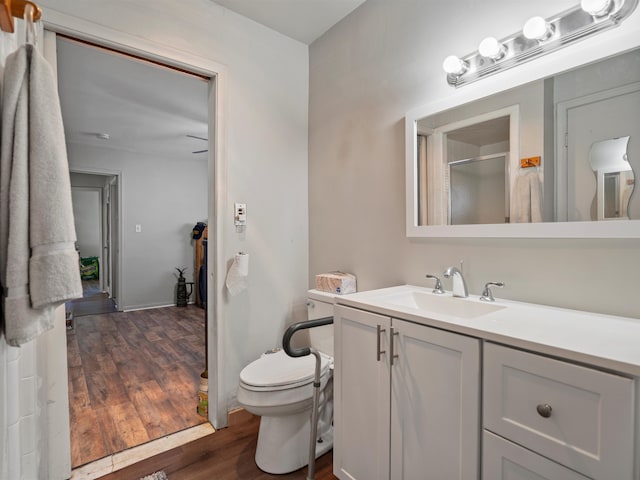 24730 Ridgedale St, Oak Park, MI 48237 - bathroom featuring wood finished floors, a shower stall, vanity, and toilet