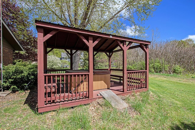 view of home's community with a hot tub, a wooden deck, a lawn, and a gazebo