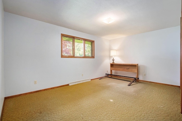 carpeted empty room with baseboards