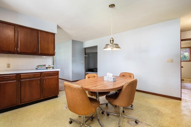 dining area with baseboards and light flooring