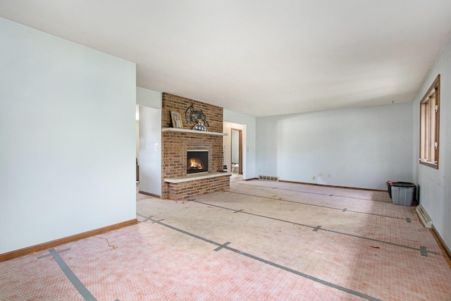 unfurnished living room with baseboards and a brick fireplace