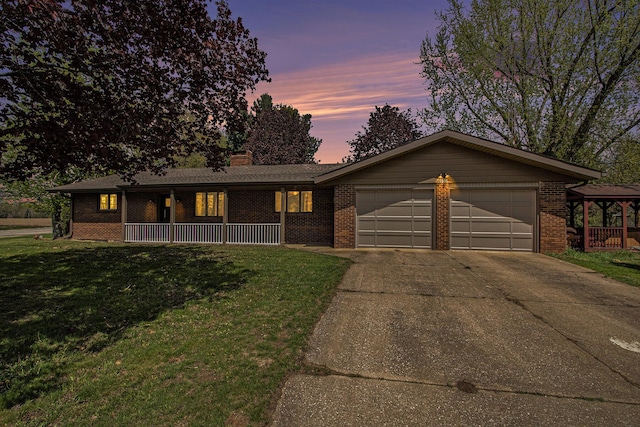 ranch-style house featuring covered porch, a garage, brick siding, and concrete driveway